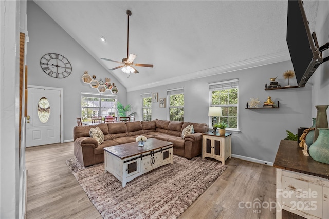 7830 Sarah Dr, Denver, NC 28037 - living room featuring ceiling fan, light wood-type flooring, high vaulted ceiling, baseboards, and ornamental molding
