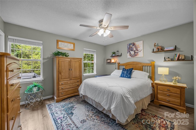 7830 Sarah Dr, Denver, NC 28037 - bedroom with light wood-style floors, ceiling fan, baseboards, and a textured ceiling