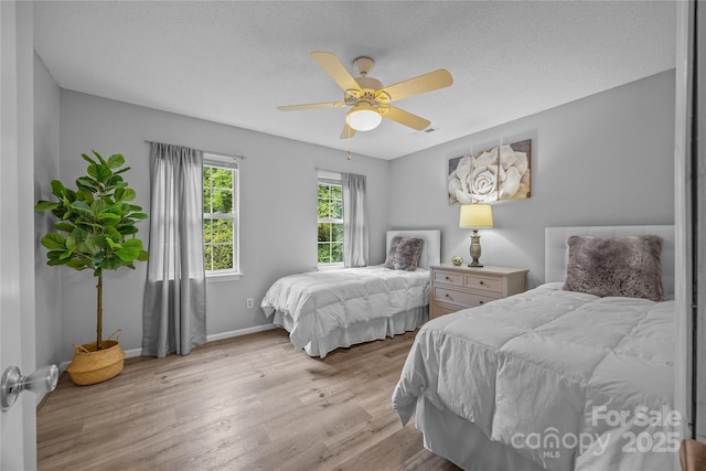 7830 Sarah Dr, Denver, NC 28037 - bedroom with wood finished floors, baseboards, ceiling fan, and a textured ceiling