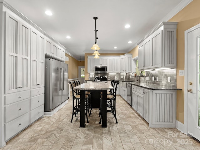 1010 Arabian Farm Rd, Clover, SC 29710 - kitchen with appliances with stainless steel finishes, ornamental molding, backsplash, dark stone counters, and decorative light fixtures