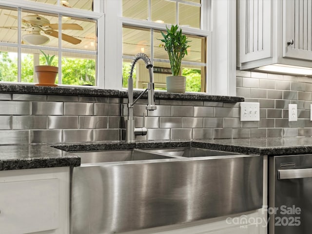 1010 Arabian Farm Rd, Clover, SC 29710 - kitchen view of a sink, decorative backsplash, stainless steel dishwasher, dark stone countertops, and white cabinetry