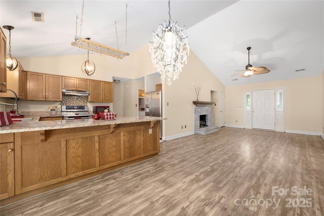 172 Valleybrook Dr Unit 8, Denver, NC 28037 - kitchen featuring under cabinet range hood, appliances with stainless steel finishes, a ceiling fan, high vaulted ceiling, and brown cabinets
