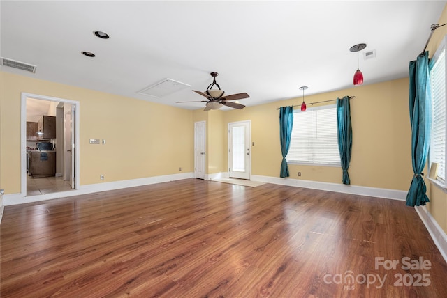 172 Valleybrook Dr Unit 8, Denver, NC 28037 - unfurnished living room featuring wood finished floors, healthy amount of natural light, ceiling fan, and attic access