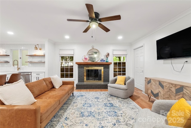 5016 Celeste Ct, Charlotte, NC 28270 - living area featuring ornamental molding, ceiling fan, light wood-style flooring, a brick fireplace, and recessed lighting
