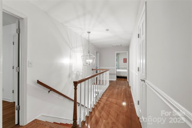 5016 Celeste Ct, Charlotte, NC 28270 - corridor featuring an upstairs landing, a chandelier, and wood finished floors