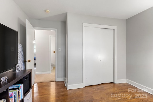 1109 S Highland Ave, Landis, NC 28088 - bedroom with wood finished floors, a closet, and baseboards