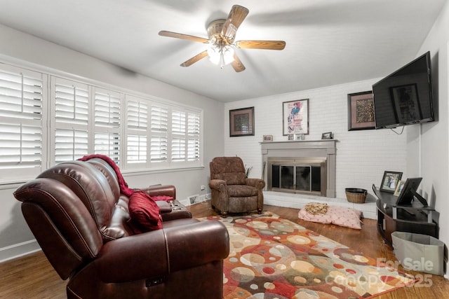 1109 S Highland Ave, Landis, NC 28088 - living area featuring brick wall, wood finished floors, ceiling fan, and a glass covered fireplace