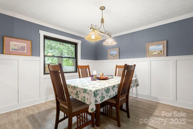 1109 S Highland Ave, Landis, NC 28088 - dining area with a decorative wall, crown molding, and light wood-style flooring