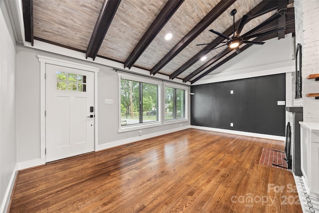 605 Cobb St, Lowell, NC 28098 - foyer entrance with wood finished floors, wooden ceiling with exposed beams, a ceiling fan, baseboards, and a fireplace with flush hearth