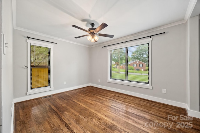 605 Cobb St, Lowell, NC 28098 - empty room with healthy amount of natural light, ornamental molding, baseboards, and wood finished floors