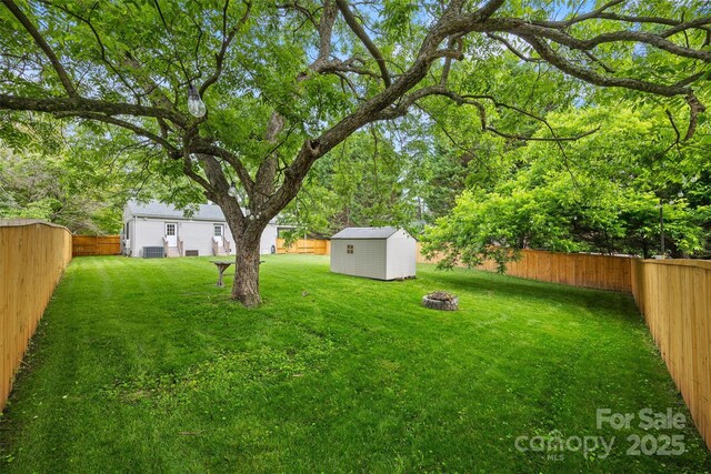 605 Cobb St, Lowell, NC 28098 - view of yard featuring an outdoor fire pit and central AC unit