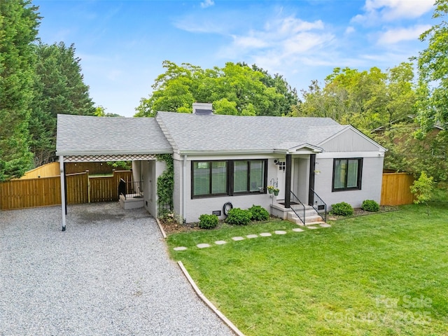 605 Cobb St, Lowell, NC 28098 - single story home with gravel driveway, a shingled roof, an attached carport, a chimney, and brick siding