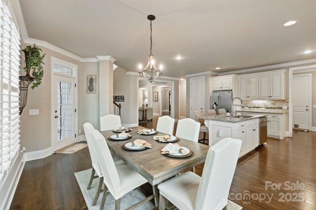 118 Tuscany Trl, Mooresville, NC 28117 - dining area featuring dark wood finished floors, a chandelier, baseboards, crown molding, and recessed lighting