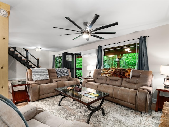 306 Mashstomp Rd, Maggie Valley, NC 28751 - living room with a wall mounted air conditioner, ceiling fan, stairs, and baseboards
