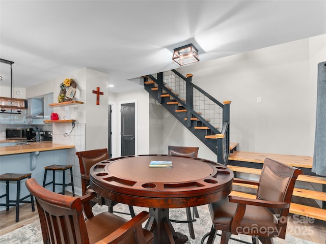 306 Mashstomp Rd, Maggie Valley, NC 28751 - dining area featuring stairs and wood finished floors