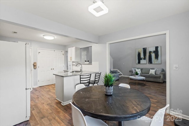1410 Swaying Branch Ln, Clover, SC 29710 - dining area featuring wood finished floors, stairway, and baseboards
