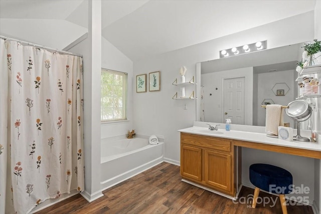 1410 Swaying Branch Ln, Clover, SC 29710 - bathroom with lofted ceiling, vanity, wood finished floors, a garden tub, and a shower with shower curtain