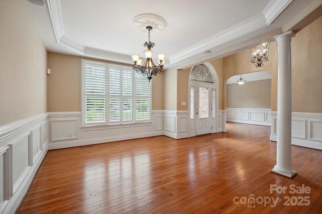 100 Woodwinds Dr, Mount Holly, NC 28120 - unfurnished dining area with a chandelier, a raised ceiling, crown molding, wainscoting, and wood-type flooring