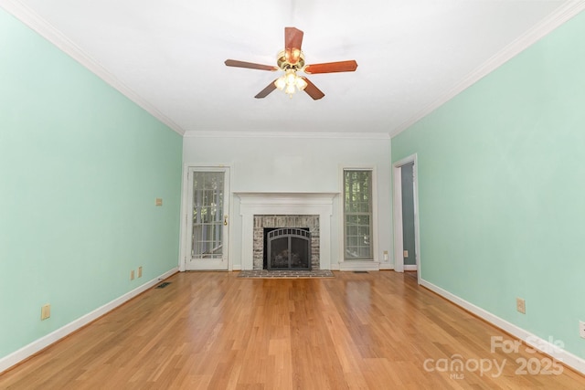1750 Trellis Dr, Rock Hill, SC 29732 - unfurnished living room with light wood-type flooring, crown molding, ceiling fan, a brick fireplace, and baseboards
