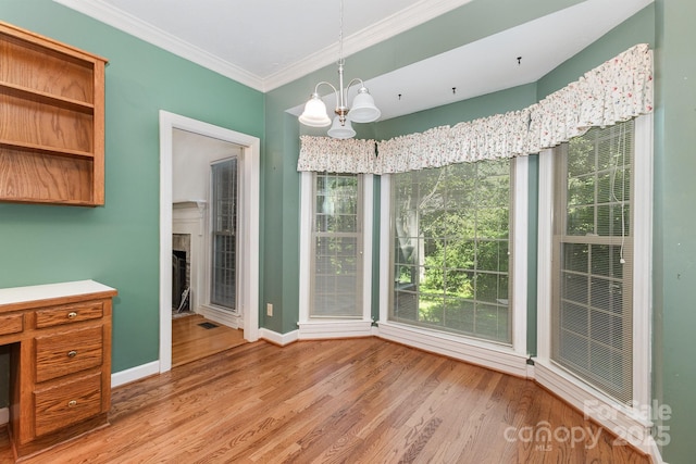 1750 Trellis Dr, Rock Hill, SC 29732 - unfurnished dining area featuring light wood-style flooring, ornamental molding, plenty of natural light, baseboards, and a chandelier