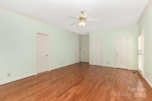 1750 Trellis Dr, Rock Hill, SC 29732 - unfurnished bedroom with light wood-type flooring, crown molding, baseboards, two closets, and ceiling fan