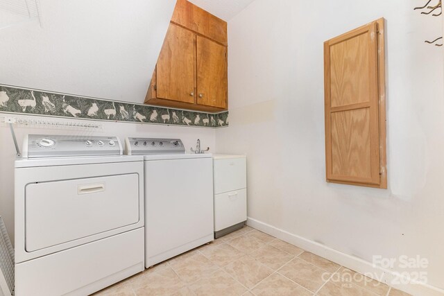 1750 Trellis Dr, Rock Hill, SC 29732 - laundry area featuring washer and dryer, cabinet space, baseboards, and light tile patterned floors