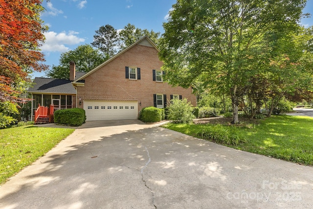 1750 Trellis Dr, Rock Hill, SC 29732 - view of front of house featuring brick siding, driveway, a garage, a front lawn, and a chimney