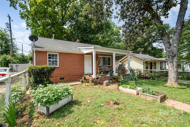 2217 Tate St, Charlotte, NC 28216 - view of front of home featuring a vegetable garden, crawl space, brick siding, and roof with shingles
