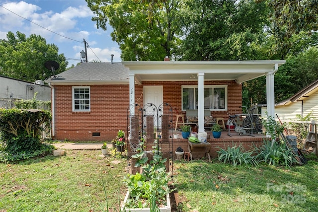 2217 Tate St, Charlotte, NC 28216 - bungalow with brick siding, covered porch, crawl space, and a front lawn