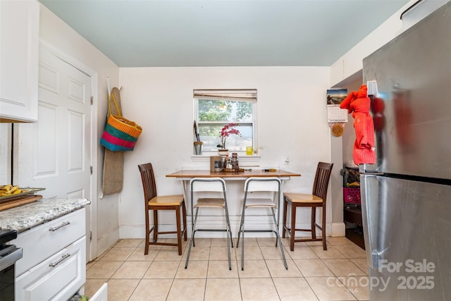 2217 Tate St, Charlotte, NC 28216 - dining room featuring light tile patterned floors and baseboards