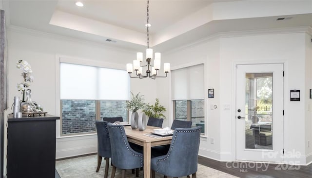 407 Newstyle Way, Gastonia, NC 28056 - dining area with a chandelier, dark wood finished floors, a tray ceiling, crown molding, and baseboards