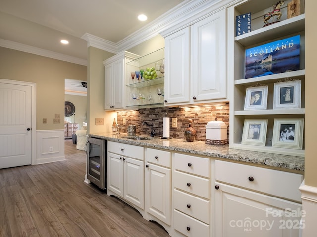 41 Annakesta Ct, Brevard, NC 28712 - bar area featuring beverage cooler, crown molding, a sink, a wainscoted wall, and backsplash