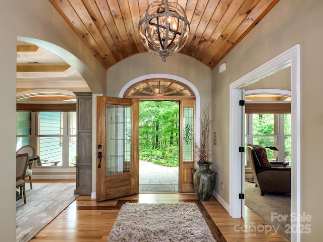 41 Annakesta Ct, Brevard, NC 28712 - entrance foyer featuring a chandelier, lofted ceiling, arched walkways, light wood-style floors, and baseboards