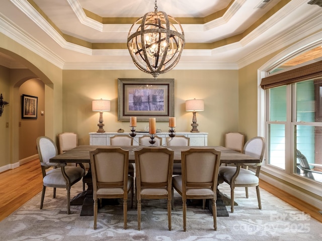 41 Annakesta Ct, Brevard, NC 28712 - dining area featuring a chandelier, arched walkways, ornamental molding, wood finished floors, and a raised ceiling