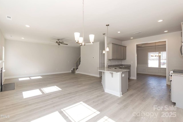 236 Mountain Island Rd Unit 40, Statesville, NC 28677 - kitchen featuring a chandelier, a peninsula, gray cabinets, light wood-style floors, and a sink