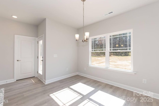 236 Mountain Island Rd Unit 40, Statesville, NC 28677 - unfurnished dining area with a chandelier, light wood finished floors, and baseboards