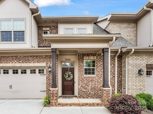 5030 Waldron Meadow Dr, Charlotte, NC 28226 - view of exterior entry featuring brick siding, a garage, concrete driveway, and stucco siding