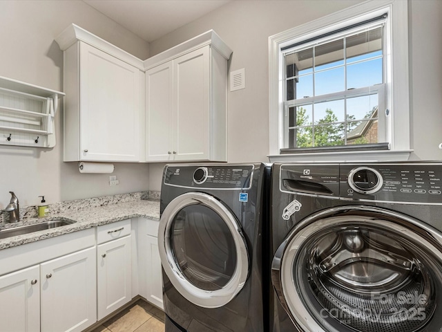 5030 Waldron Meadow Dr, Charlotte, NC 28226 - laundry area featuring washing machine and dryer, cabinet space, and light tile patterned floors