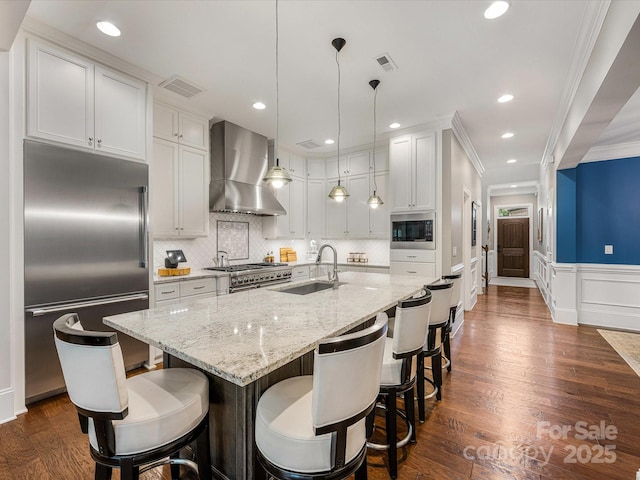 5030 Waldron Meadow Dr, Charlotte, NC 28226 - kitchen with built in appliances, wall chimney exhaust hood, a sink, ornamental molding, and white cabinetry