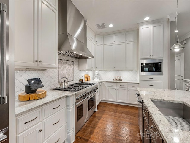 5030 Waldron Meadow Dr, Charlotte, NC 28226 - kitchen featuring wall chimney exhaust hood, stainless steel appliances, tasteful backsplash, white cabinets, and recessed lighting
