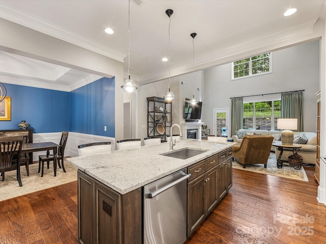 5030 Waldron Meadow Dr, Charlotte, NC 28226 - kitchen featuring stainless steel dishwasher, a sink, open floor plan, dark brown cabinets, and crown molding