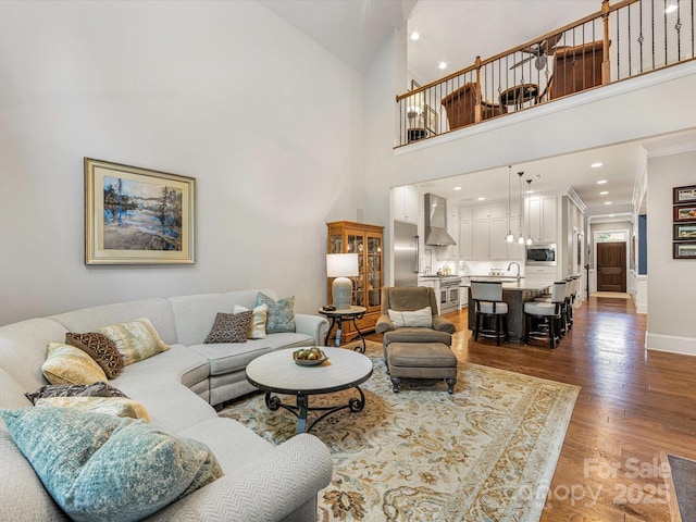 5030 Waldron Meadow Dr, Charlotte, NC 28226 - living area featuring baseboards, wood finished floors, a towering ceiling, crown molding, and recessed lighting