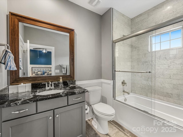 5030 Waldron Meadow Dr, Charlotte, NC 28226 - bathroom featuring vanity, toilet, combined bath / shower with glass door, and wainscoting