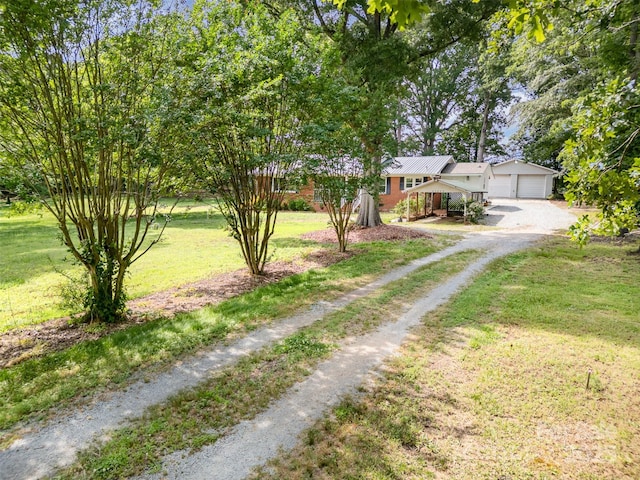 2320 Doster Rd, Monroe, NC 28112 - view of front of house with dirt driveway, a front yard, and a garage