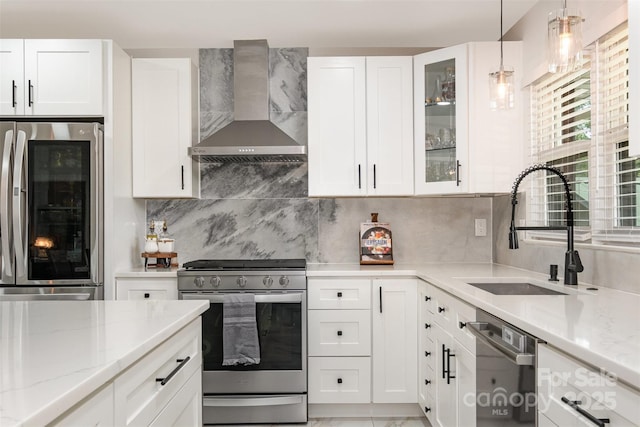 2320 Doster Rd, Monroe, NC 28112 - kitchen featuring wall chimney range hood, stainless steel appliances, a sink, light stone countertops, and white cabinetry