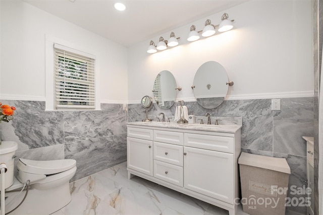 2320 Doster Rd, Monroe, NC 28112 - full bath with tile walls, wainscoting, toilet, double vanity, and marble finish flooring