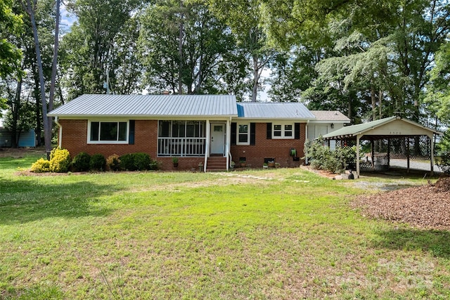 2320 Doster Rd, Monroe, NC 28112 - single story home featuring a front lawn, metal roof, a carport, and brick siding