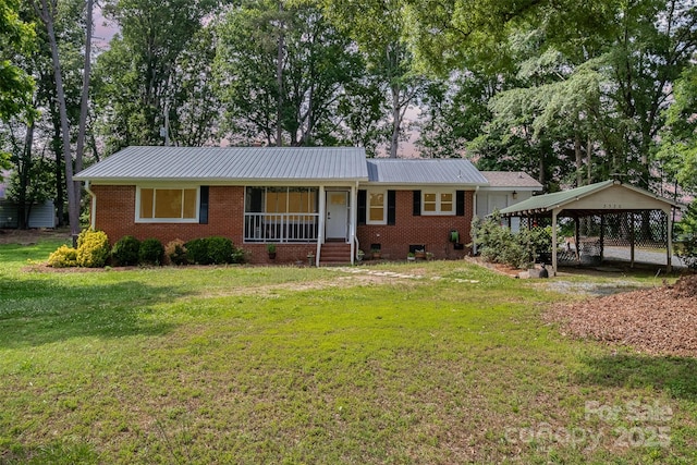 2320 Doster Rd, Monroe, NC 28112 - single story home with a front lawn, a porch, brick siding, metal roof, and a detached carport