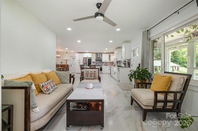 2320 Doster Rd, Monroe, NC 28112 - living area featuring a ceiling fan, recessed lighting, light marble finish flooring, and a chandelier