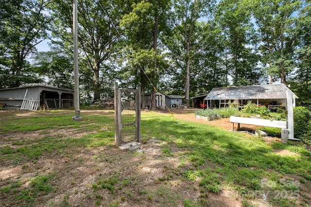 2320 Doster Rd, Monroe, NC 28112 - view of grassy yard with an outbuilding and an outdoor structure